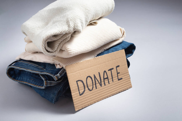 Used denim jeans and clothes for donation, donate sign - Foto, imagen
