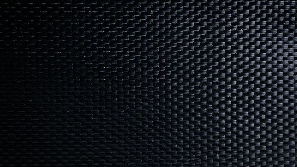 Mesh black texture. Dark polyester fiber material for sport cloth or abstract weave background. Synthetic pattern for backpacks and sports equipment - Photo, Image