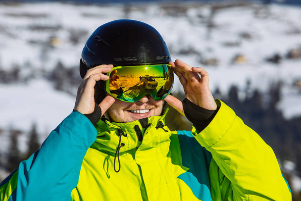 man in helmet and ski mask. reflection. winter activity. sunny day - Photo, Image