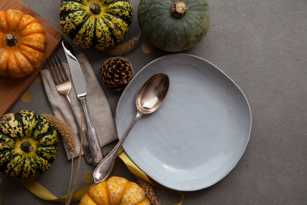Overhead autumn thanksgiving dinner place setting with pumpkins cutlery and an empty plate - Zdjęcie, obraz