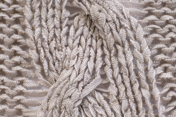 Soft light natural texture of knitted wool textile material background. White crochet cotton fabric woven canvas texture close up - Foto, Imagen