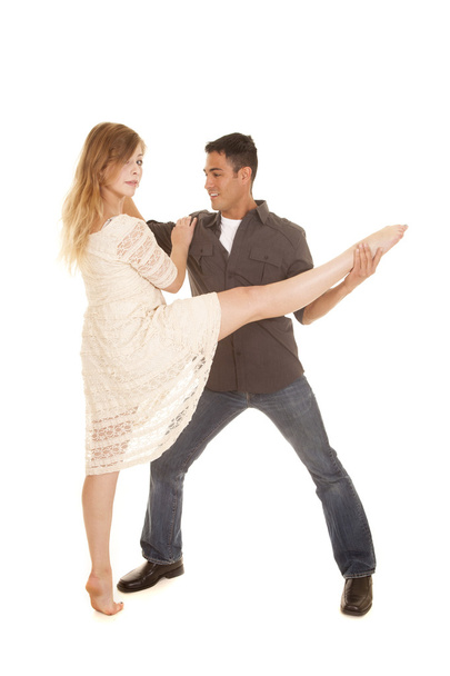 woman in white dress dance with man grab her leg - Foto, immagini