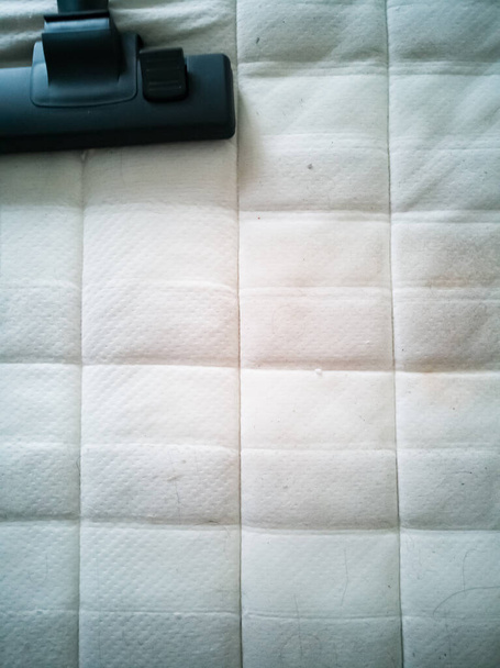 Cleaning the mattress with vacuum cleaner at home. - Photo, Image