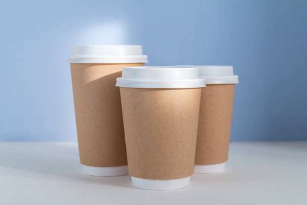 group of paper cups against blue background, greenwashing concept - Photo, Image