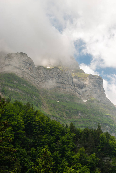 Appenzell, Switzerland, June 13, 2021 Summit in the alps surrounded with clouds in the summer time - 写真・画像