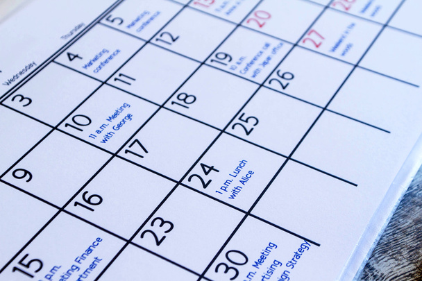 Checking monthly activities in the calendar - Photo, Image