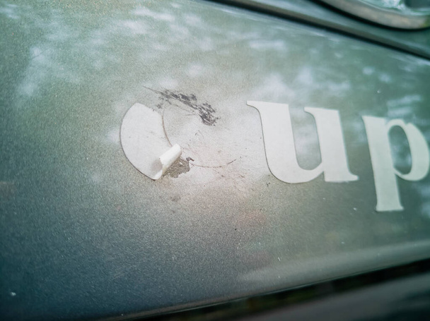 Old sticker on the car. Remove the adhesive letter from the car body. - Photo, Image