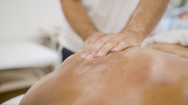 Hands doing back relaxing massage - Fotó, kép