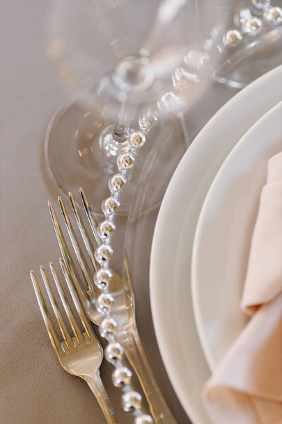 Forks, plates, glasses close-up. Beautiful table setting. High quality photo - Photo, Image