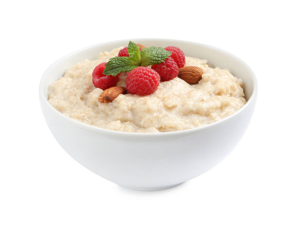 Tasty oatmeal porridge with raspberries and almond nuts in bowl on white background - Photo, Image