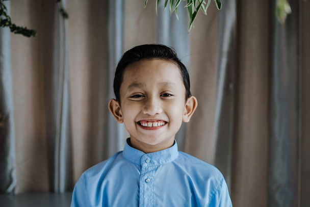 Portrait of south asian handsome little boystanding and smiles. Malaysian people. - Φωτογραφία, εικόνα