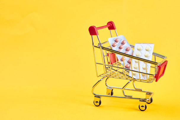 drug trolleys service delivery shopping pharmacy yellow background - Zdjęcie, obraz