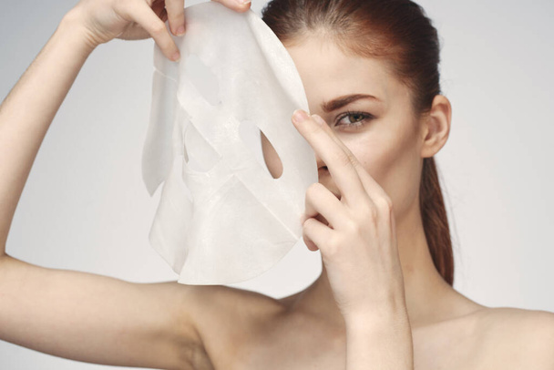 woman with mask in hands skin care rejuvenation spa treatments - Valokuva, kuva