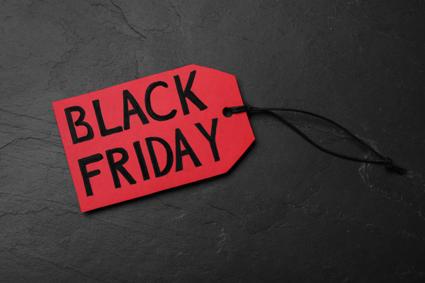 Red tag with words Black Friday on dark stone background, top view - Fotografie, Obrázek