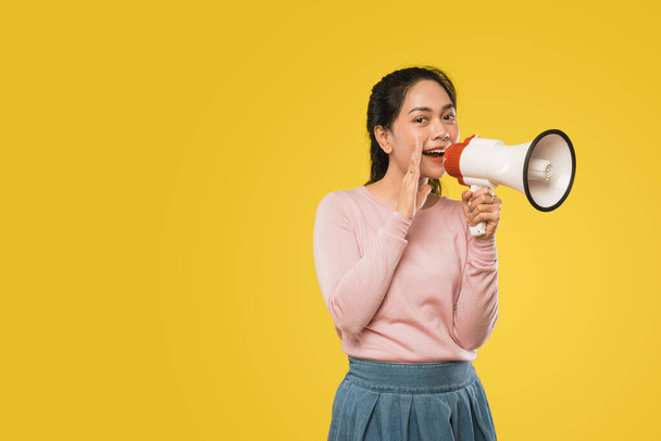 girl with hands beside mouth making announcement using megaphone - Фото, изображение