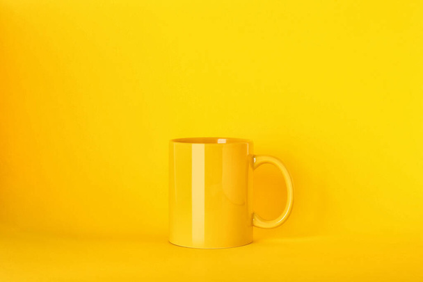 New blank ceramic mug on yellow background - Photo, Image