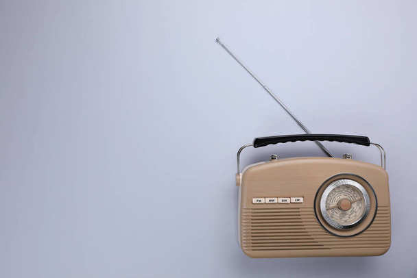 Retro radio receiver on light grey background, top view. Space for text - Foto, Imagen