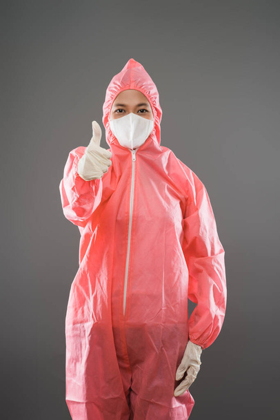 a doctor standing in red PPE and mask with thumbs up while facing front - Zdjęcie, obraz