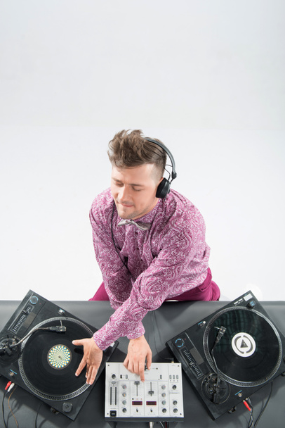 Top view portrait of dj mixing and spinning turntable - Φωτογραφία, εικόνα