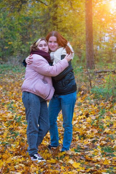 two red-haired smiling girls against the background of autumn nature, the concept of human emotions. - Foto, Imagem