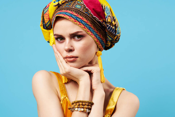 cheerful woman with  ethnicity multicolored headscarf  on isolated background. High quality photo - Foto, imagen