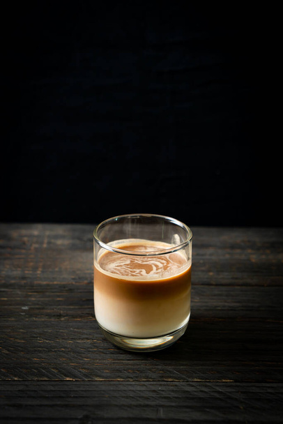 glass of latte coffee, coffee with milk on wood background - Fotó, kép