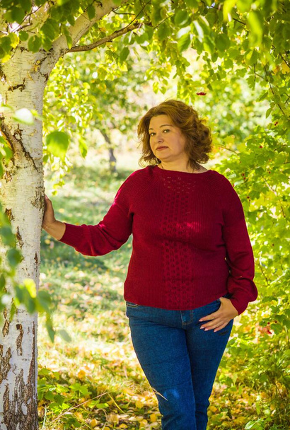 Portrait of attractive plus size mature woman in casual style walk at good sunny autumn day and thinking about something. Life of women after 40-50 years - Photo, Image