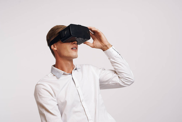 Cheerful man virtual reality glasses high-tech simulator technology studio - Foto, immagini