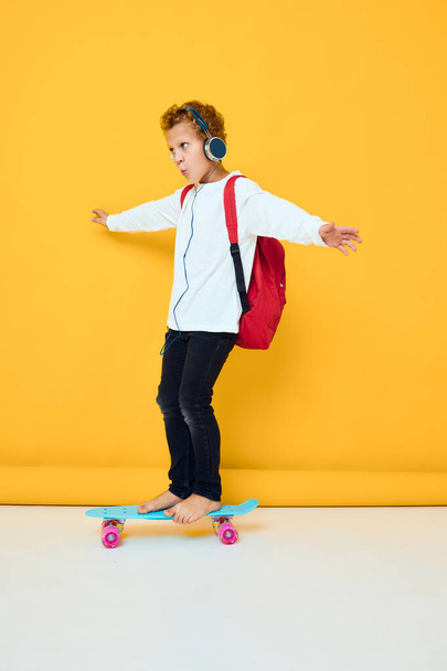 schoolboy blue skateboard headphone entertainment active urban lifestyle of youth - Foto, Imagem