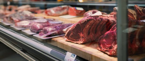 Showcase with raw meat in butcher shop. - Foto, immagini