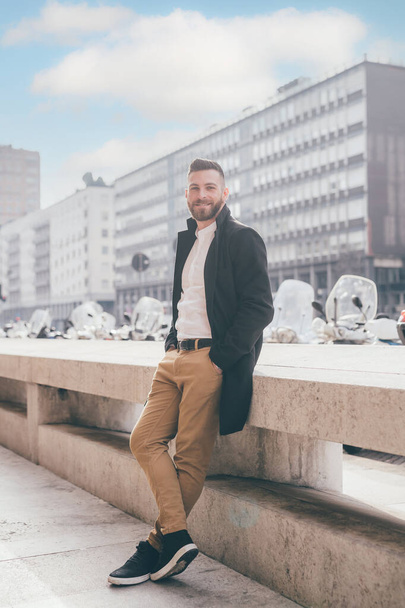 Young bearded caucasian successful business man outdoors posing smiling positive and confident - Fotó, kép