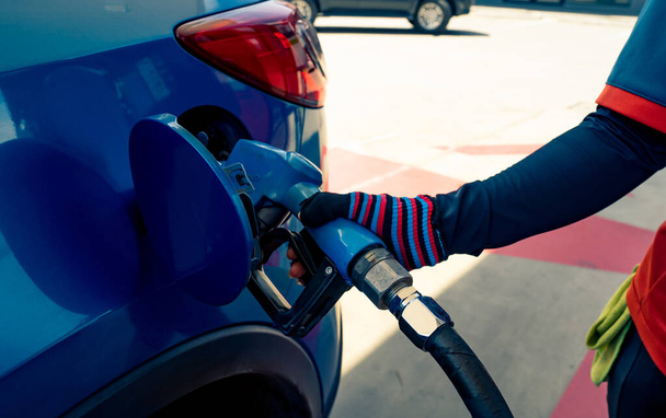 Car fueling at gas station. Refuel fill up with petrol gasoline. Petrol pump filling fuel nozzle in fuel tank of car at gas station. Petrol industry and service. Petrol price and oil crisis concept. - Photo, Image