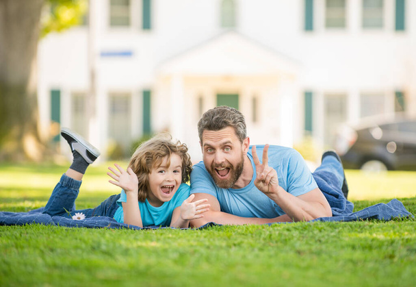childhood and parenthood. parent relax with little child boy on grass. dad with kid - Foto, Bild