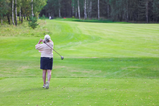 Golfer with a putter on the field. - Valokuva, kuva