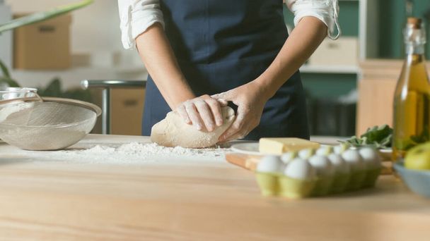 Professional Chef Kneads Dough for Baking on a Wooden Kitchen Table. - Photo, Image