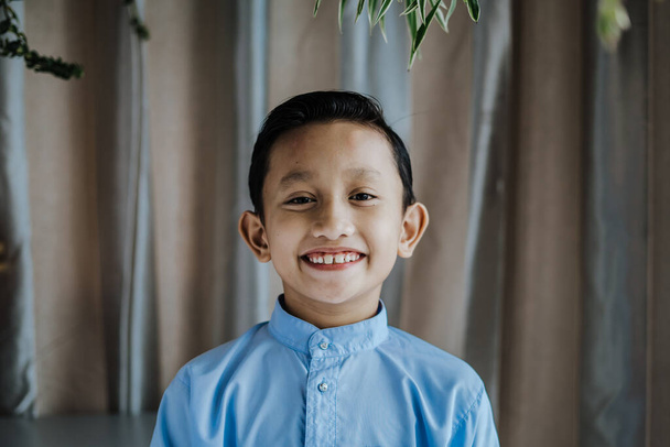 Portrait of south asian handsome little boystanding and smiles. Malaysian people. - Φωτογραφία, εικόνα