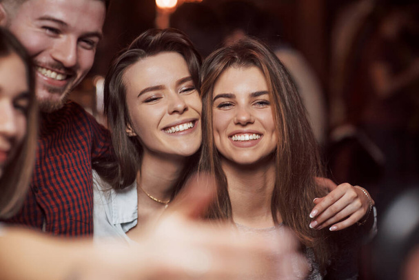 Feeling happy. Beautiful youth have party together in the nightclub. - Photo, image