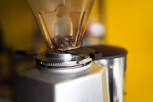 close-up fresh in coffee grinder prepare to mill , tool and machine background blur - Zdjęcie, obraz