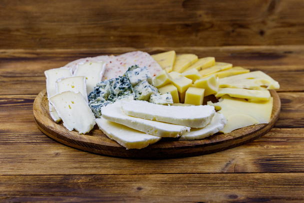 Cheese platter with different kinds of cheese on wooden table - 写真・画像