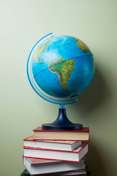 stacked books with globe. High quality photo - 写真・画像