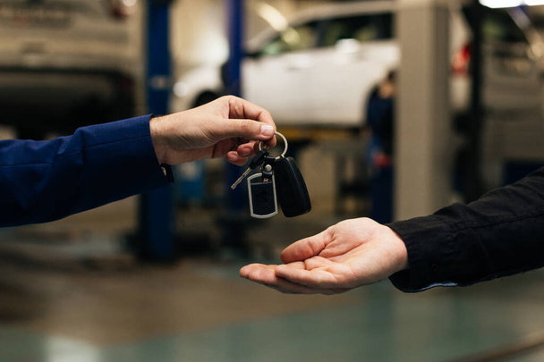 Car key handover, a transport ownership or leasing concept - Photo, Image