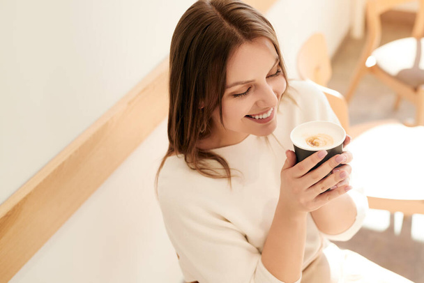 Woman enjoying coffee in cafe in morning - 写真・画像