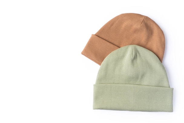 Two beanie hats in pastel colors for comfortable autumn and winter weather with a place for text on a white background - Zdjęcie, obraz