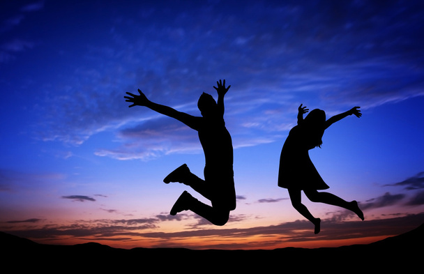 Силуэты пары, прыгающей на фоне заката
 - Фото, изображение
