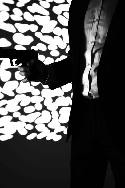 Retro secret agent with pistol revolver gun in hand in vintage crime thriller mockup cover     photo.        - Photo, Image