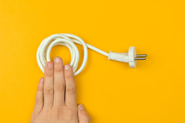 Electrical power cable plug, EU type, yellow background, flat lay and top view - Valokuva, kuva