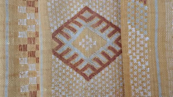 Folded, handmade, traditional, Moroccan cactus silk (Sabra silk) rug, carpet, in yellow. Closeup abstract geometric patterns, handwoven with Berber design. - Footage, Video