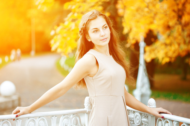 Autumn woman. Beautiful young trendy girl in autumn park - 写真・画像