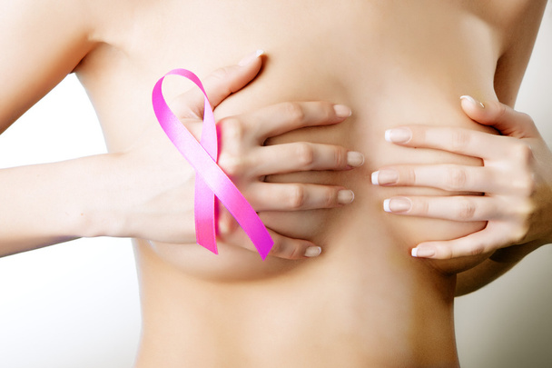 Breast cancer. Pink ribbon on a woman's breasts. Concept of medi - Valokuva, kuva