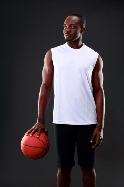 Handsome sports african man over black background - 写真・画像